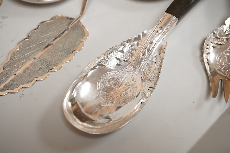A small collection of mainly Malaysian white metal items including four hardwood handled servers, an 800 standard bowl, flower spreader and three small dishes.